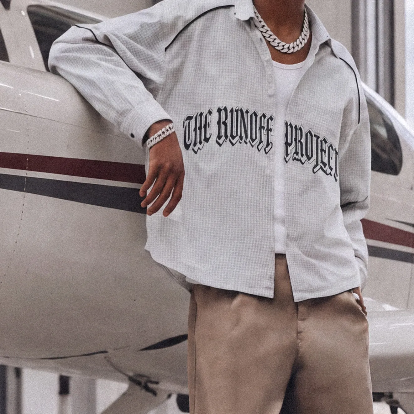 White grid overshirt with The Runoff Project across the chest