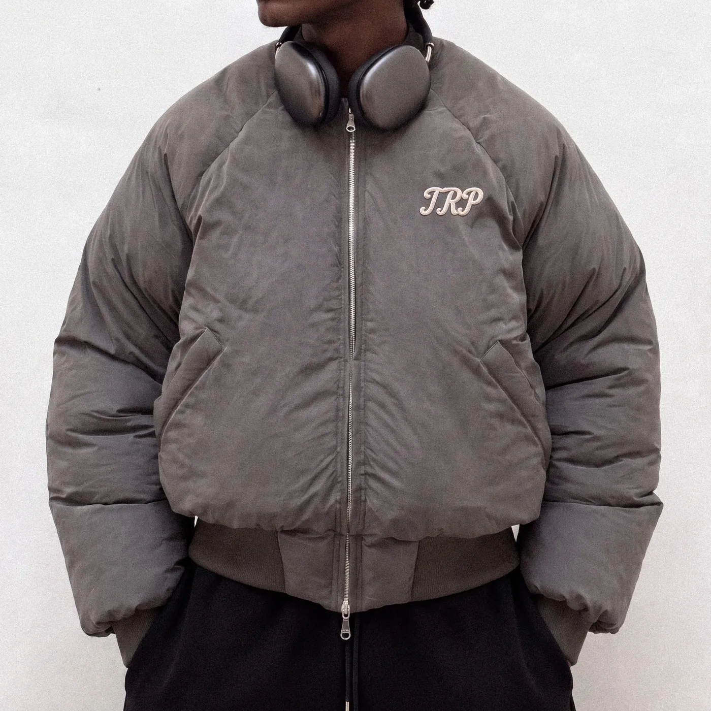 Charcoal TRP puffer bomber jacket with a script logo