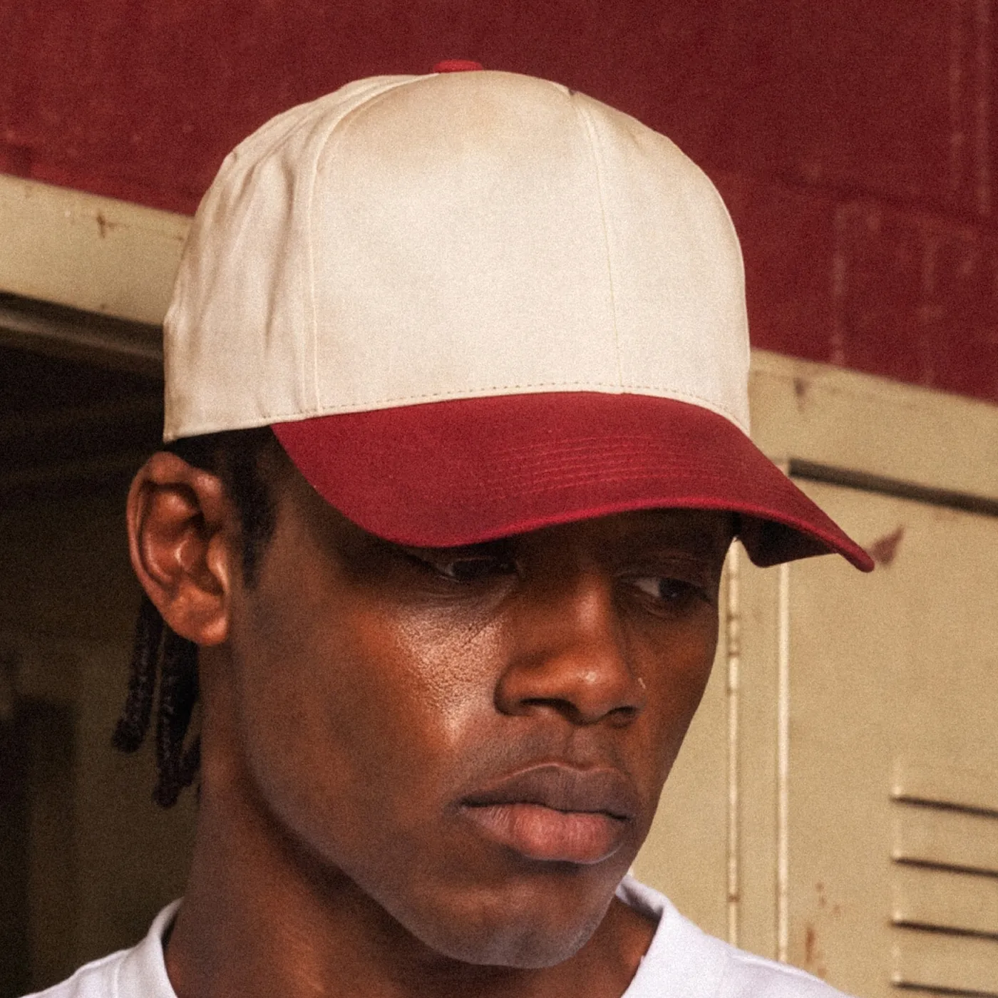 Cream TRP cap with a burgundy peak